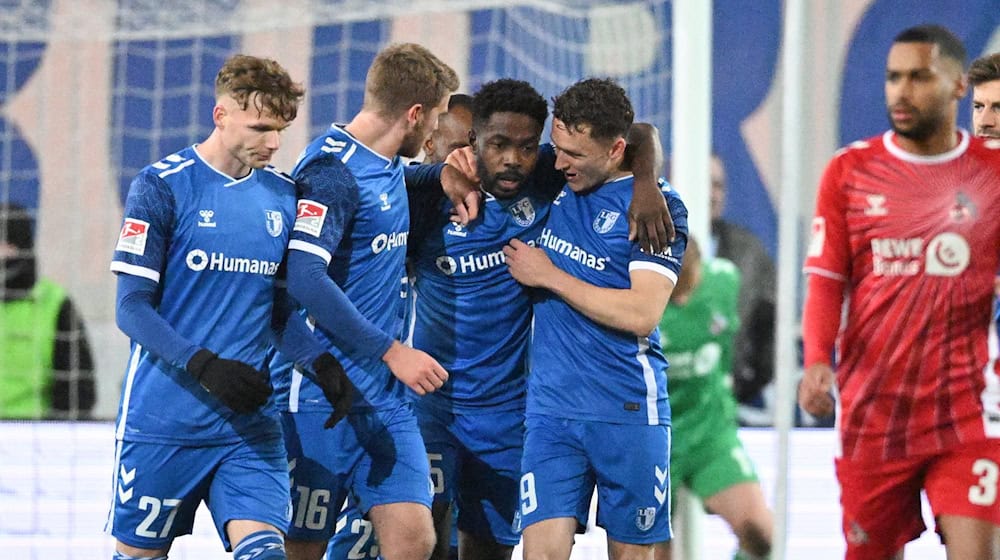 The Magdeburgers celebrate after the 1:0 goal by Daniel Heber (M). / Photo: Christophe Gateau/dpa