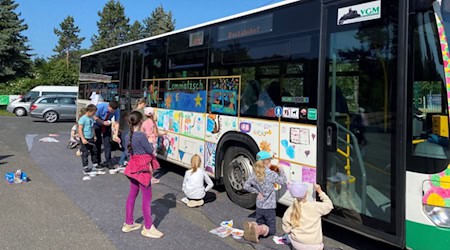 Kinder beim Bemalen des Literaturbusses. Foto: VGM