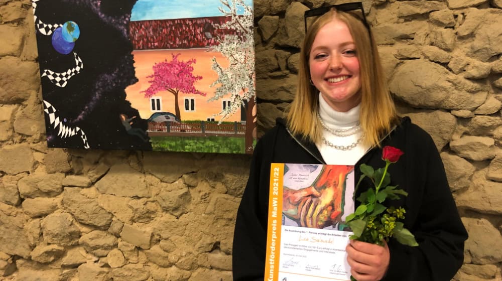Lea Salzwedel vor ihrer Arbeit, mit der sie den MaWi-Kunstförderpreis 2022 gewonnen hat. Foto: Stadtverwaltung Bischofswerda