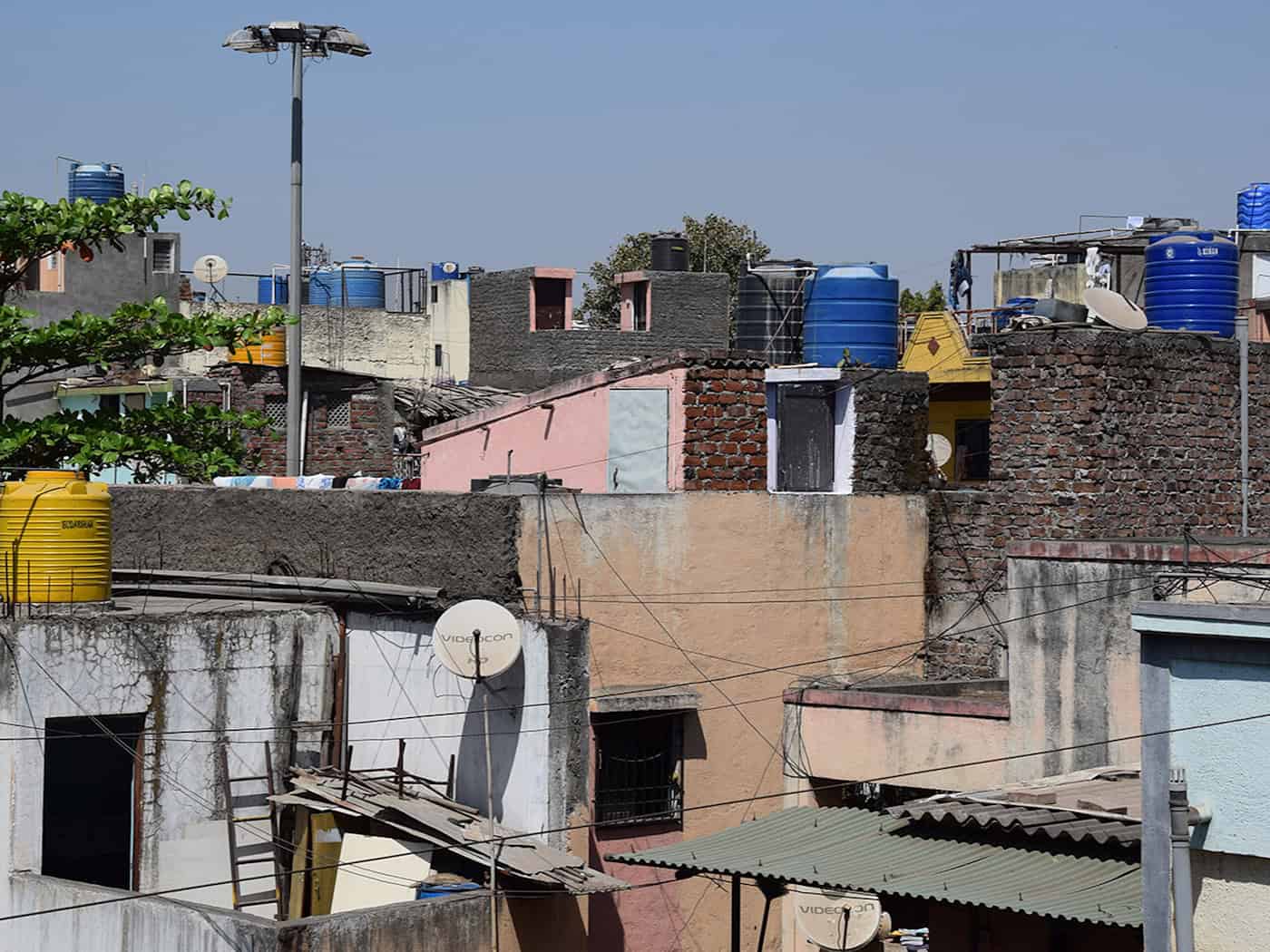 Water barrels on rooftops ensure the supply of water to many households in Pune.