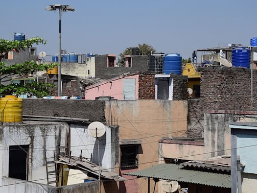 Water barrels on rooftops ensure the supply of water to many households in Pune.