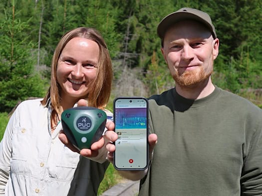 Martina Buchna, Rangerin im Nationalpark Bayerischer Wald, zeigt Dr. Stefan Kahl von der TU Chemnitz einen Audiologger zur Tonaufnahme im Wald.