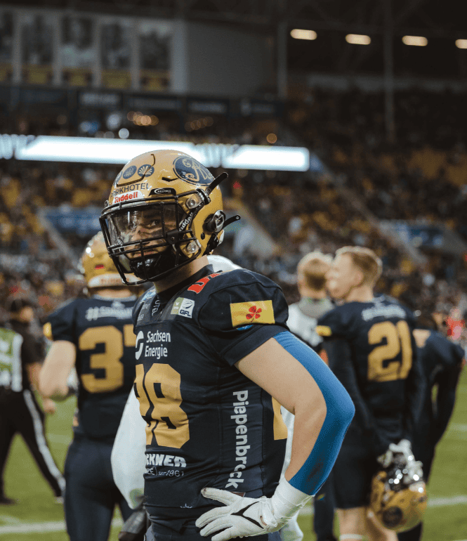 Spieler der Dresden Monarchs beim GFL Bowl 2025 im Heinz-Steyer-Stadion in Dresden – konzentriert vor einer beeindruckenden Kulisse aus Fans und Flutlicht.
