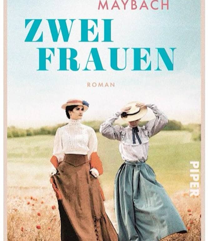 Cover des Romans „Zwei Frauen“ von Katja Maybach: Zwei Frauen in historischen Kleidern mit Hüten stehen auf einem Feldweg vor einer ländlichen Landschaft.