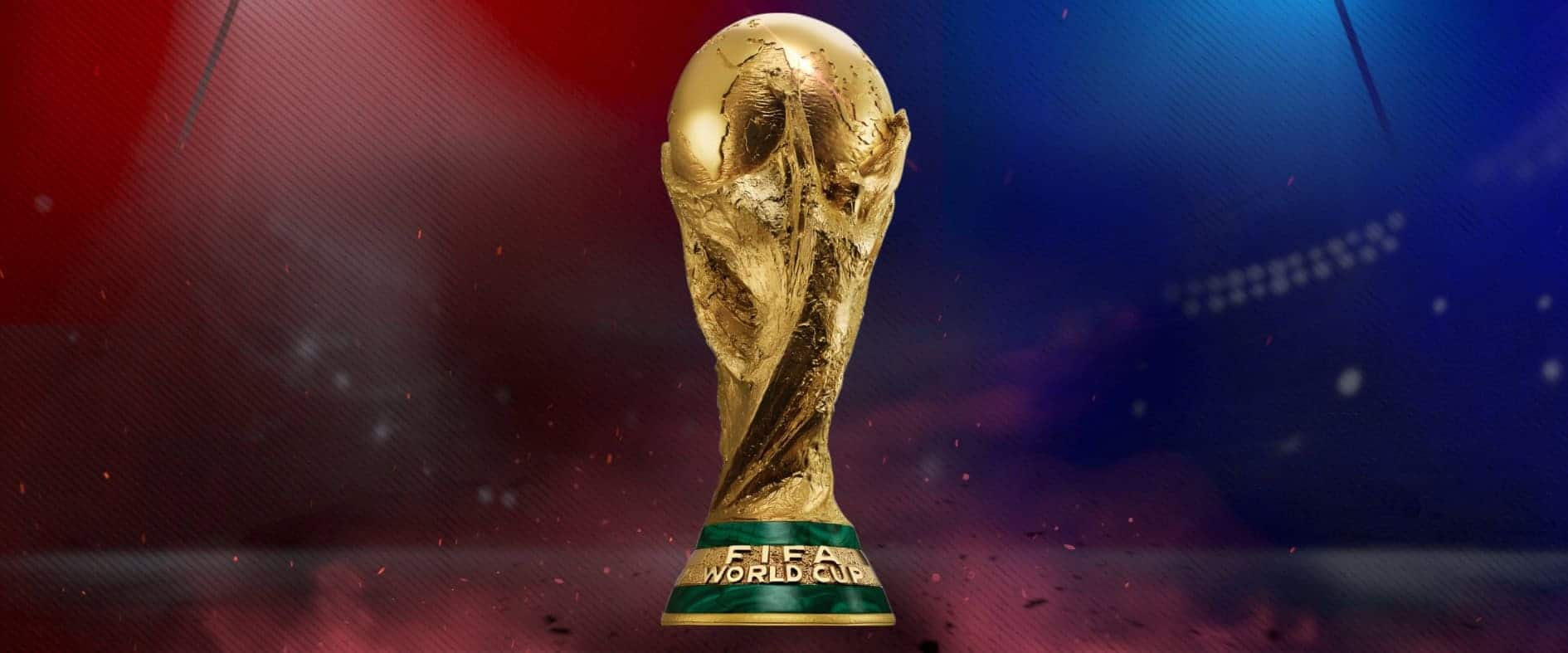 FIFA World Cup Pokal vor Stadion-Flutlicht mit roter und blauer Beleuchtung