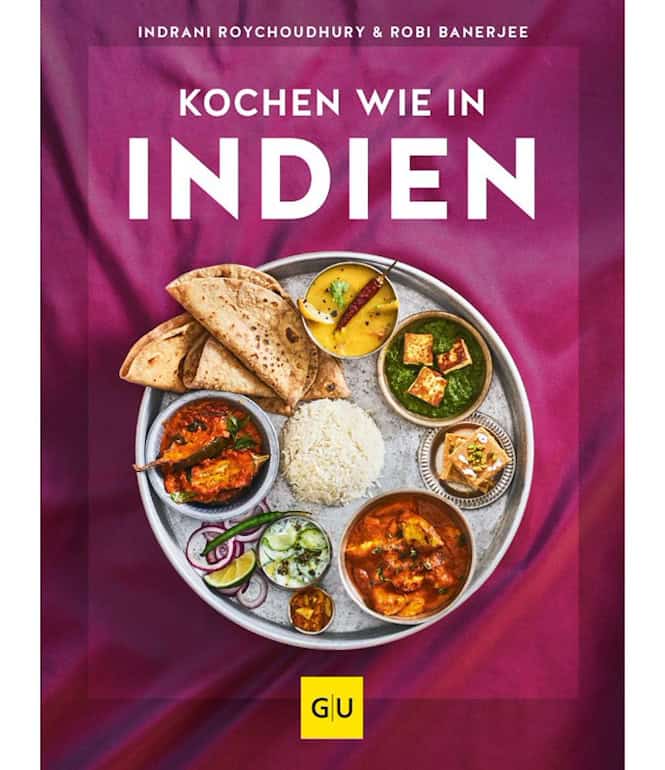 Buchcover von „Kochen wie in Indien“ mit einem traditionellen Thali-Teller, gefüllt mit indischen Spezialitäten wie Naan-Brot, Reis, Curry, Dal, Joghurt, Chutneys und Süßigkeiten auf einem pinken Hintergrund.